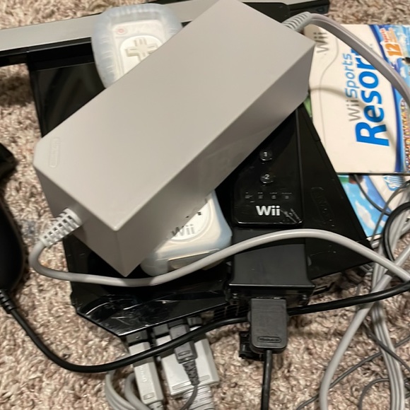Nintendo wii with all controls plugs wires and two games with extra connects